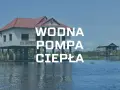 Dom na palach nad wodą, z napisem "WODNA POMPA CIEPŁA".