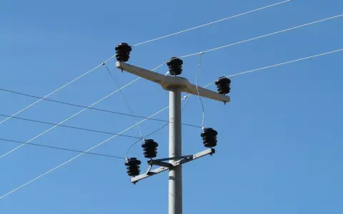 Słup energetyczny z izolatorami, na którym widać przewody elektryczne. Taryfa B23 może być związana z takim właśnie zasilaniem.
